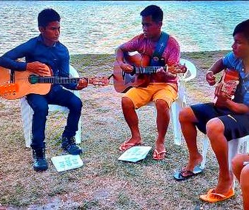 Jovens indígenas tocando violão